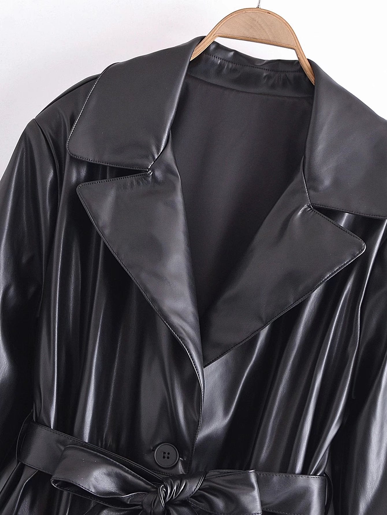 Image of Black belted faux leather trench coat