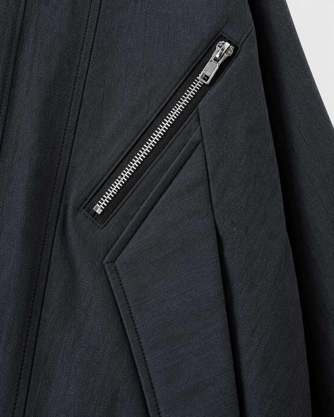 Black | Close-up of the pocket zip detail on the black zip-up jacket