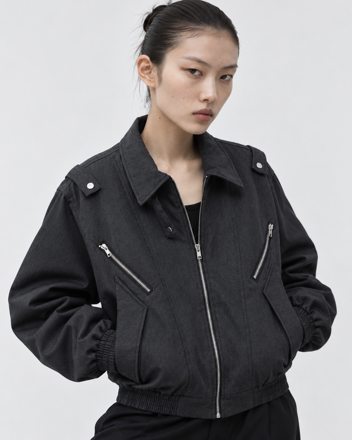 Image of Black | Female model wearing the black zip-up jacket in a second studio pose