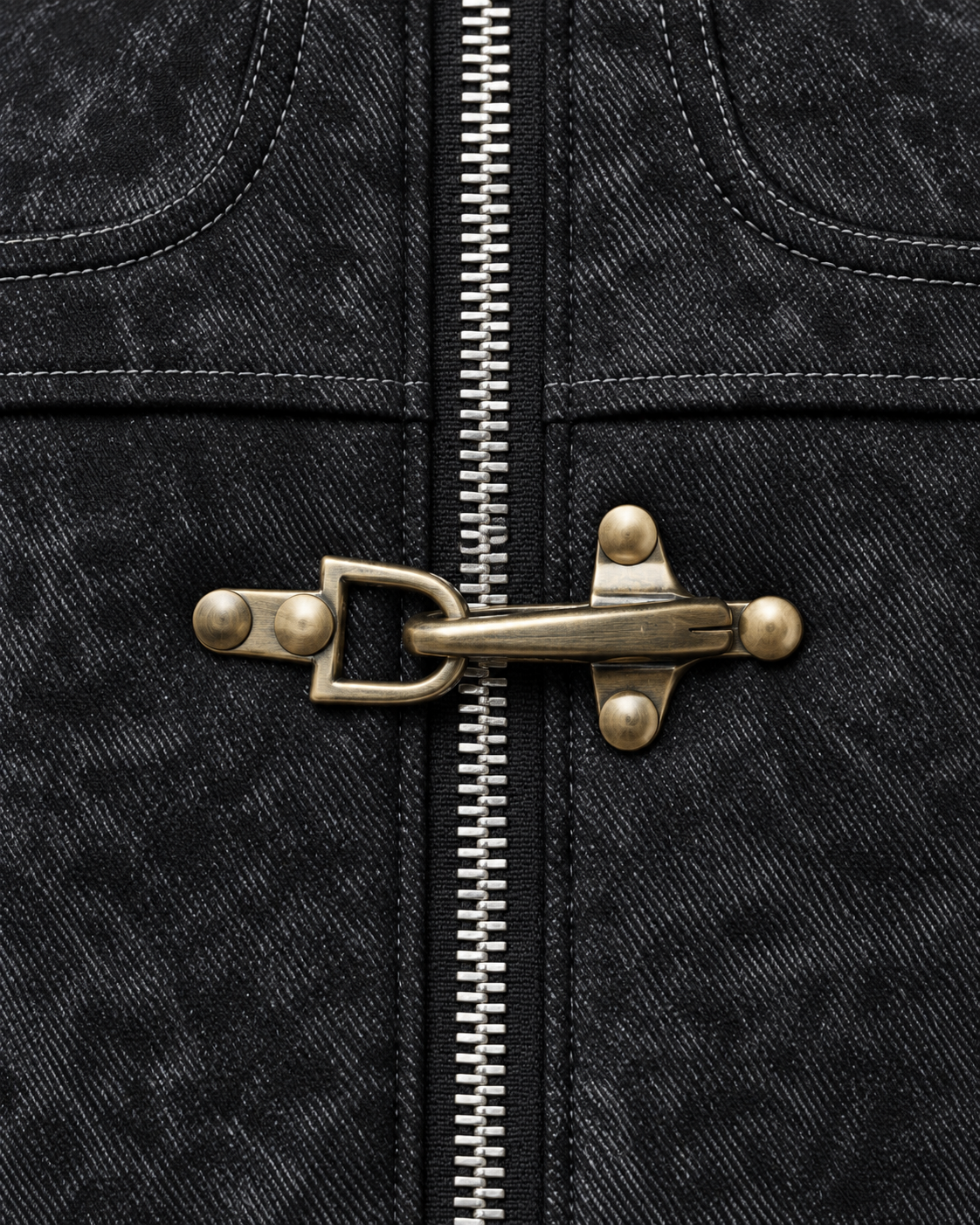 Image of Black | Close-up of the metal clasp detail on the black zip-up jacket