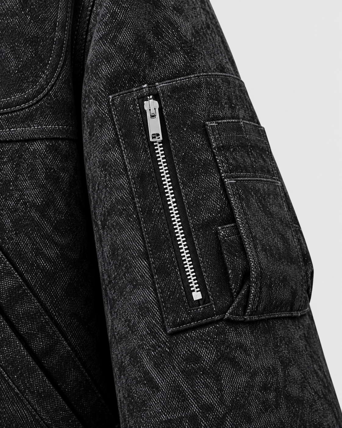 Image of Black | Close-up of the sleeve zip detail on the black zip-up jacket