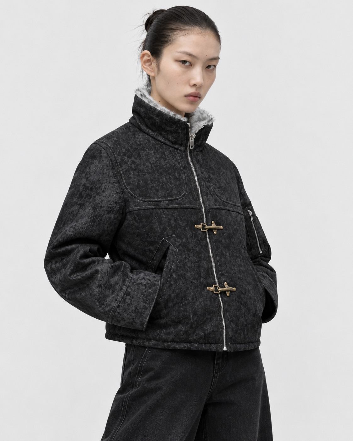 Image of Black | Female model wearing the black zip-up jacket in a second studio pose