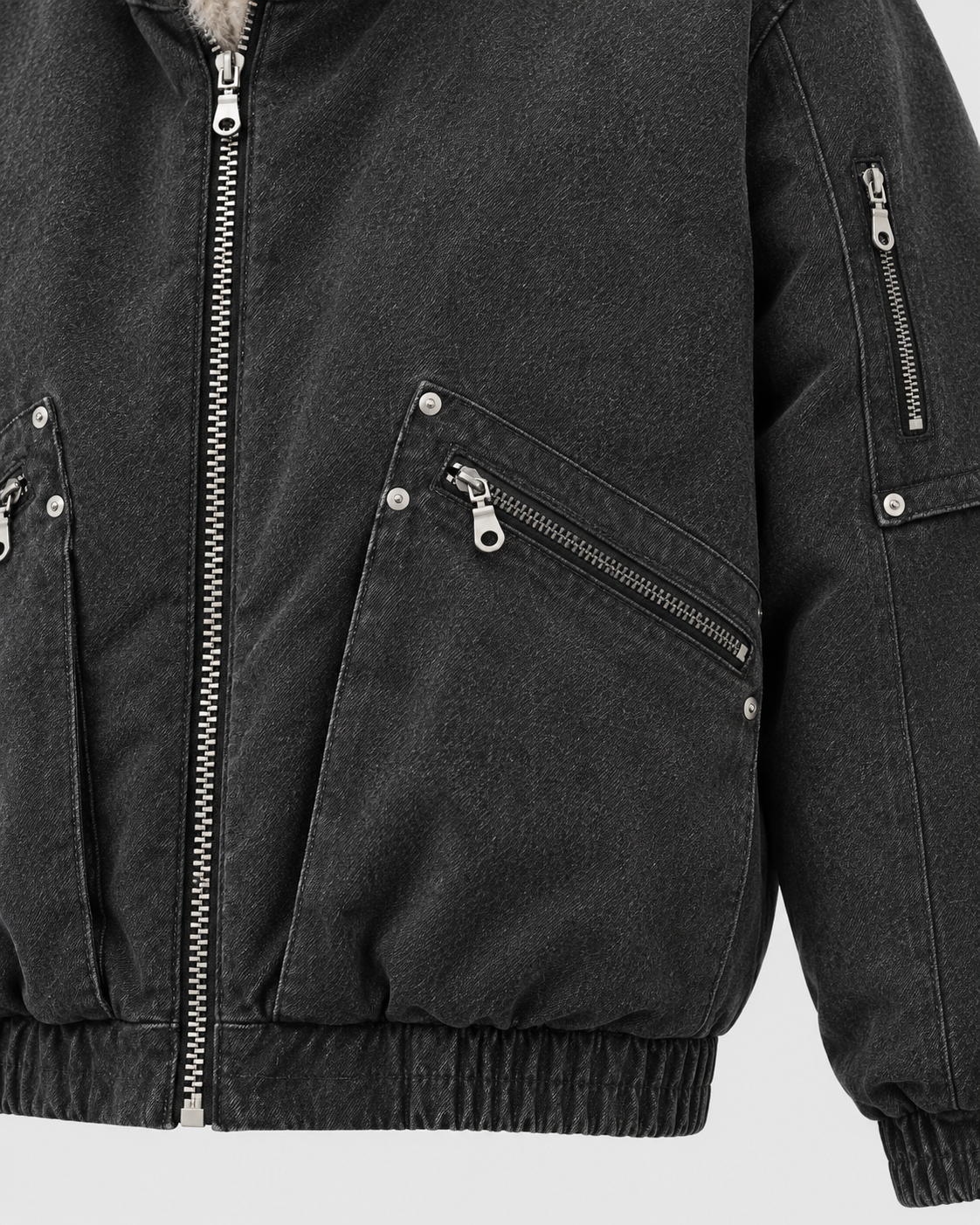 Image of Black | Close-up of the zip pocket detail on the black zip-up jacket