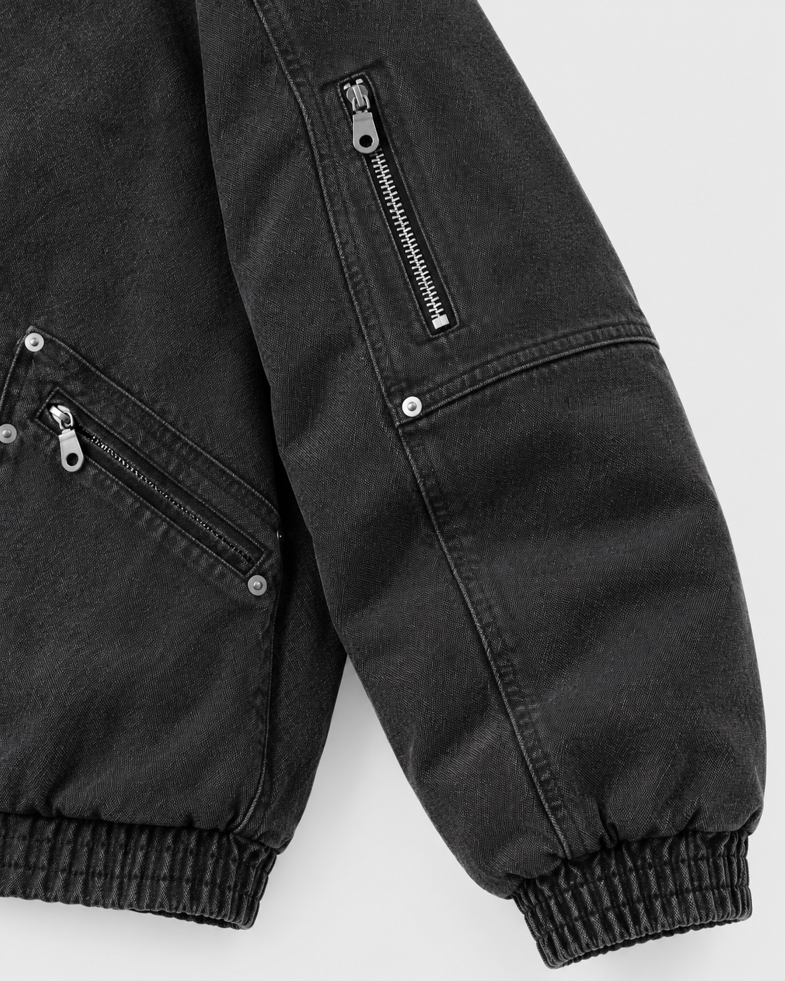 Image of Black | Close-up of the sleeve detail on the black zip-up jacket