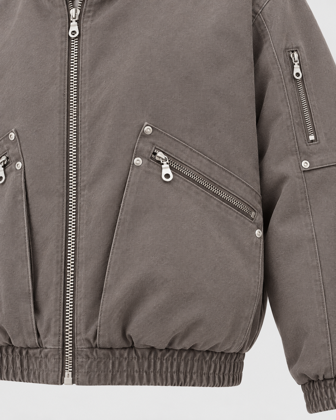 Brown | Close-up of the zip pocket detail on the brown zip-up jacket