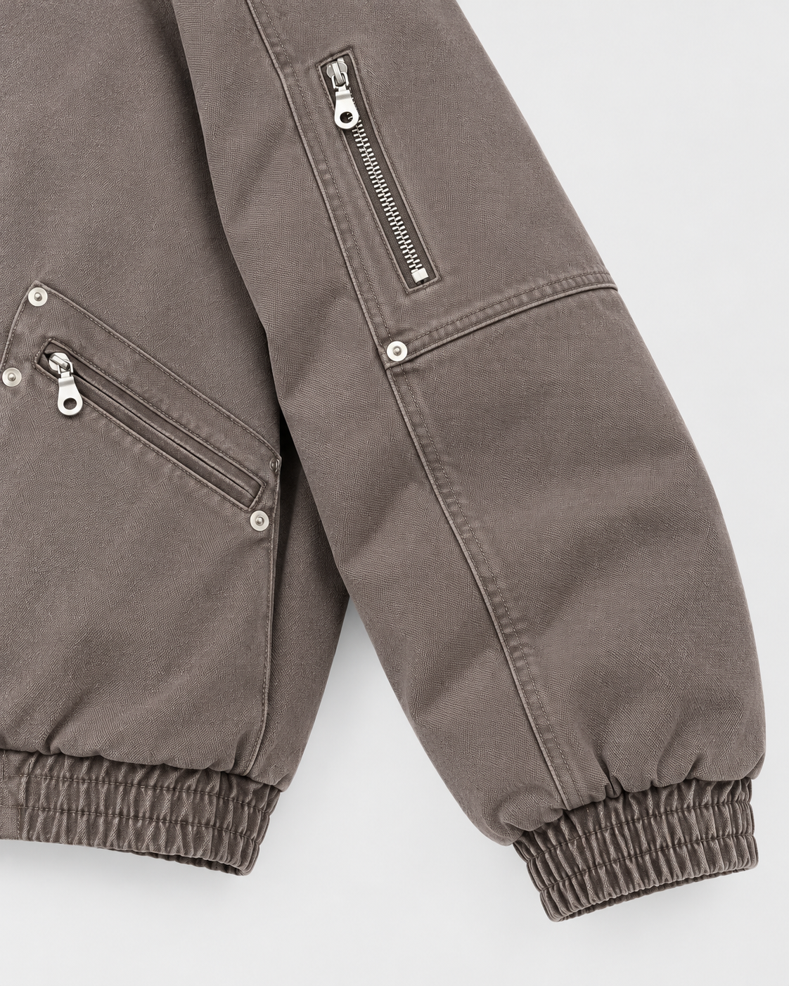 Image of Brown | Close-up of the sleeve detail on the brown zip-up jacket