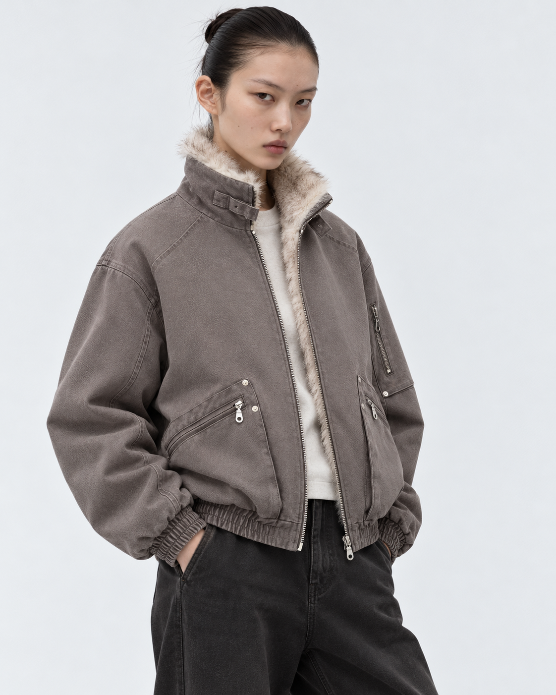 Image of Brown | Female model wearing the brown zip-up jacket in a second studio pose