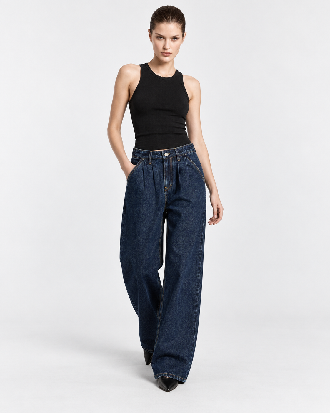 Image of Dark | Model wearing dark blue wide-leg jeans, front studio pose