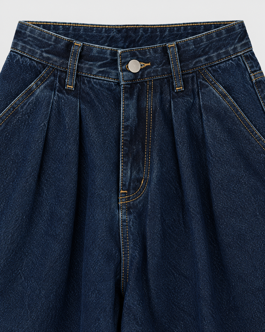 Dark | Close-up of pleated waistband on dark blue wide-leg jeans