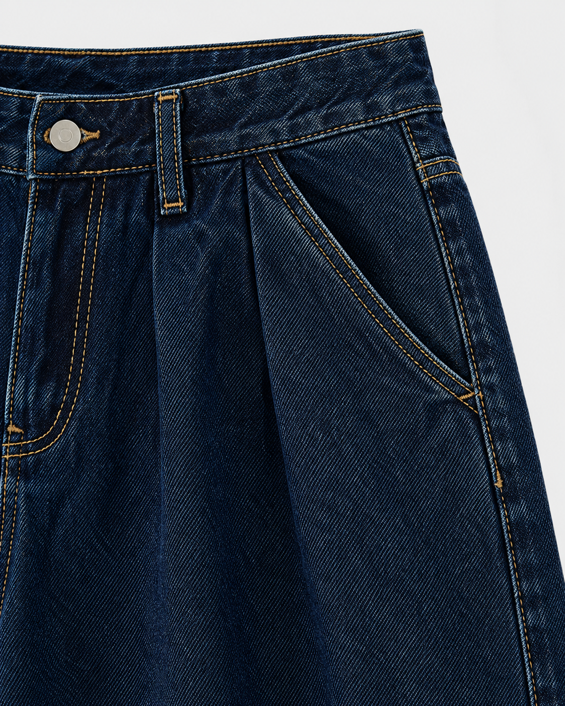 Dark | Close-up of pocket stitching and front pleat on dark wide-leg denim