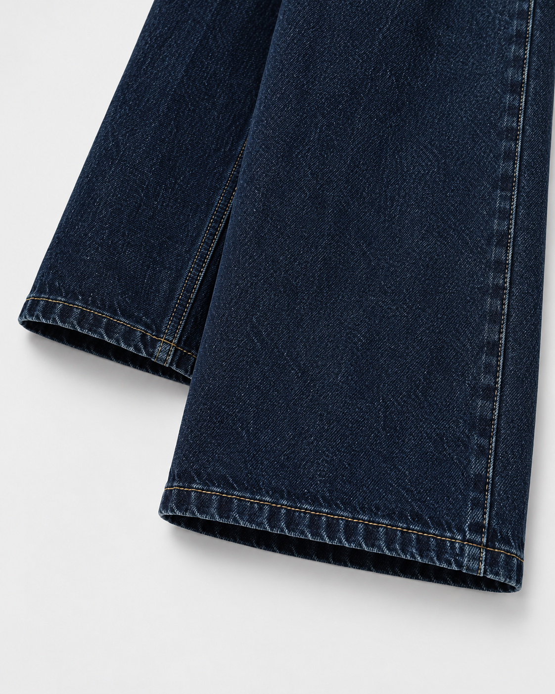 Image of Dark | Close-up of denim hem on dark blue wide-leg jeans