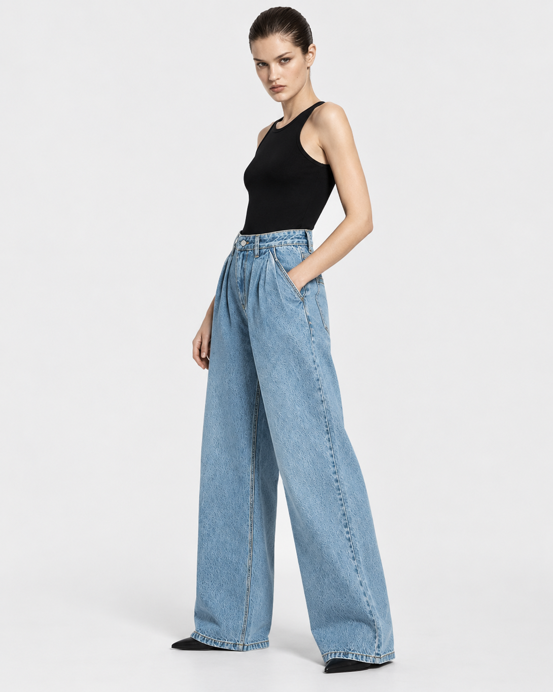 Image of Medium | Model styling medium-blue wide-leg jeans in alternate pose