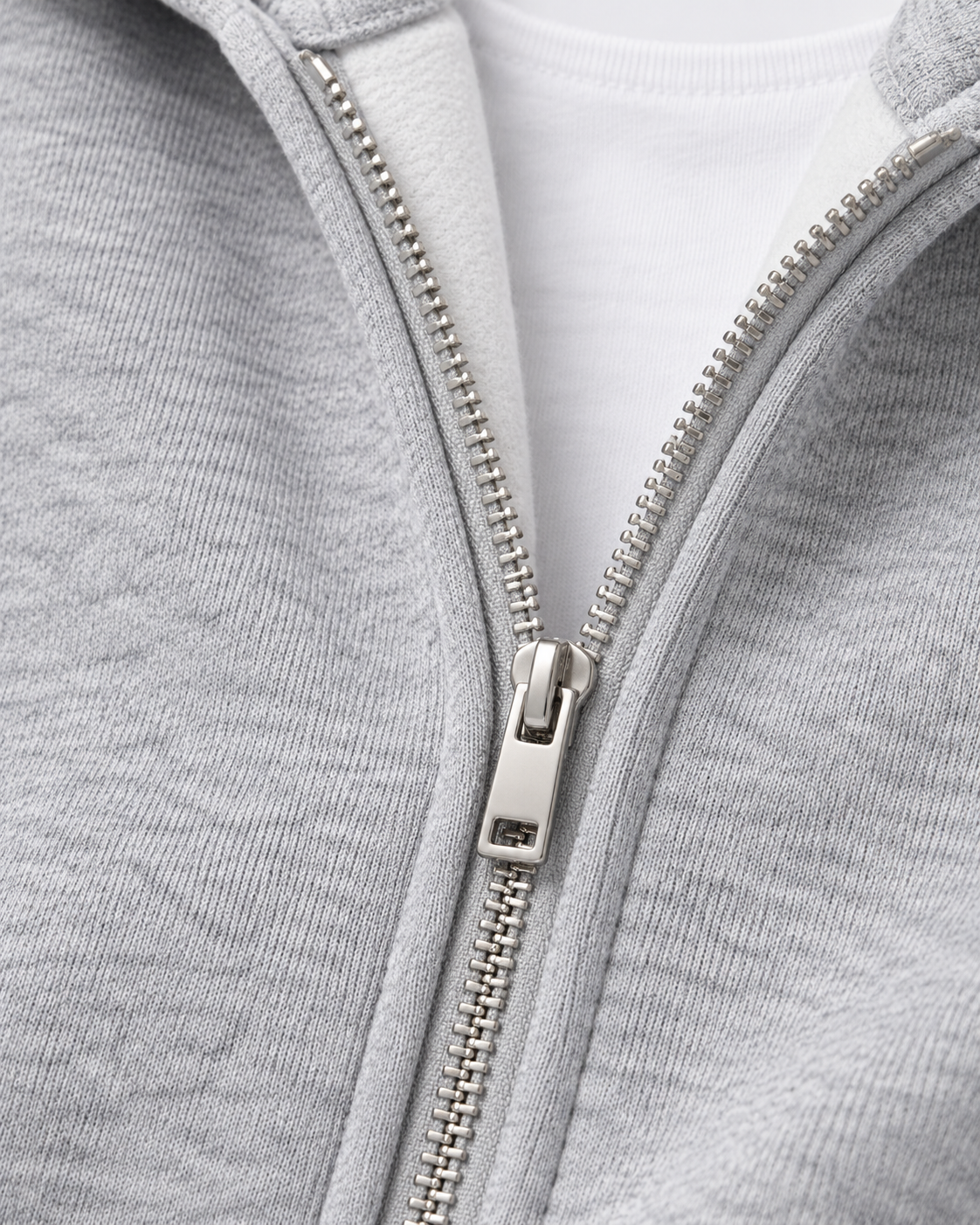 Image of Heather Gray | Close-up of the metal front zipper and cotton-blend knit texture on the heather gray hoodie