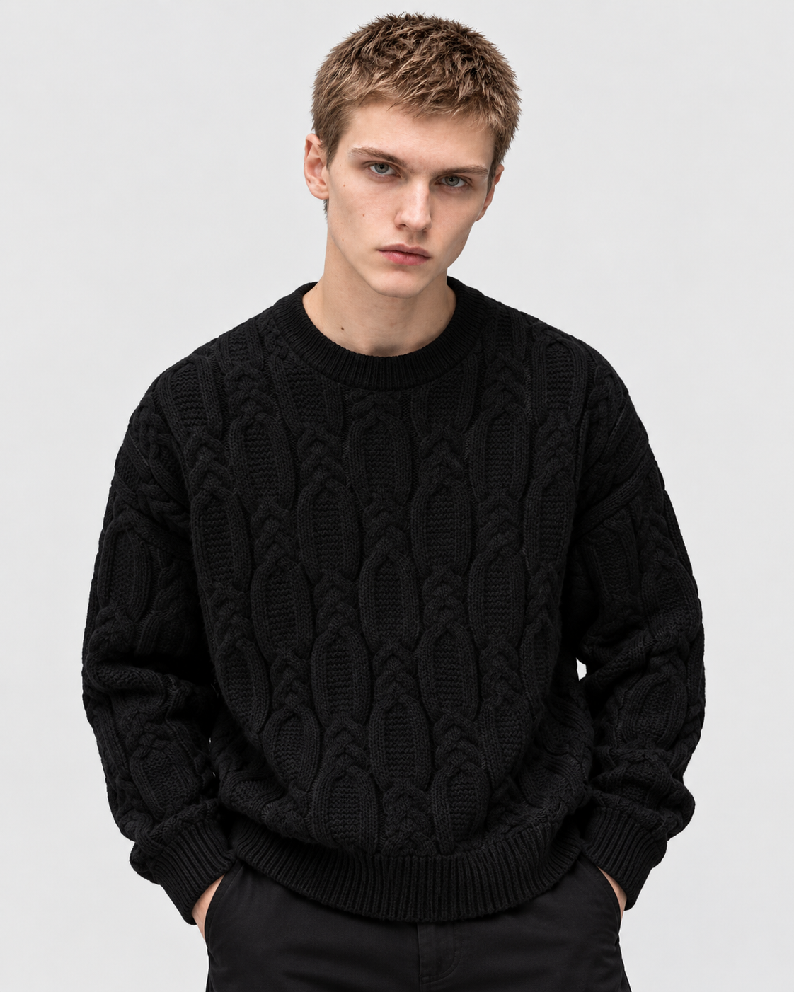 Image of Black | Male model wearing black cable-knit crewneck sweater, front standing pose