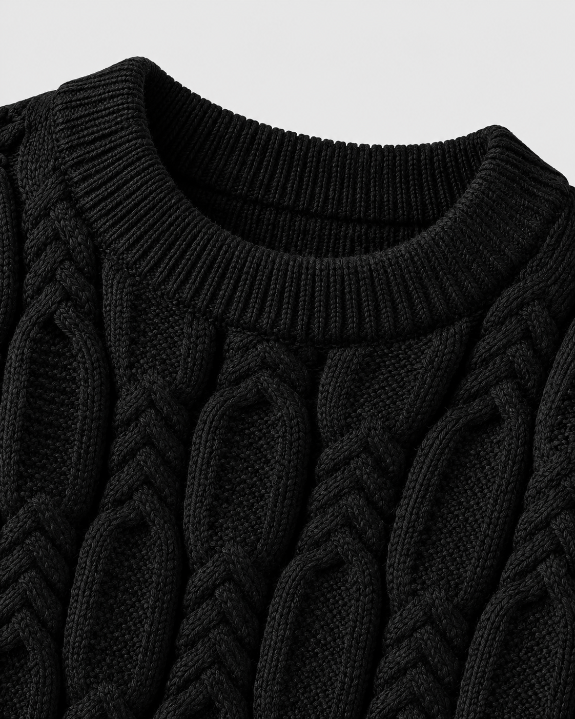 Image of Black | Close-up of black cable-knit pattern near the upper chest and collar