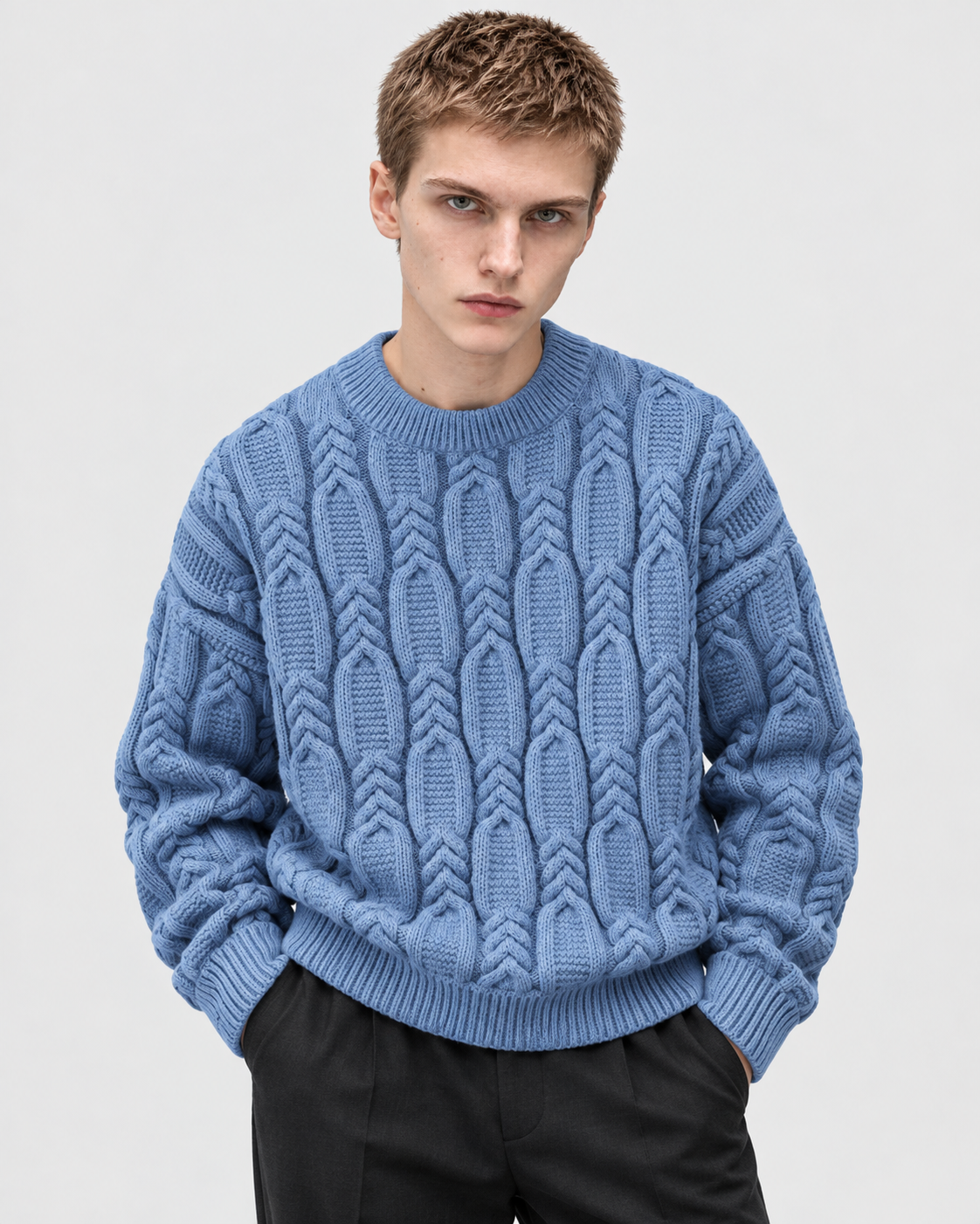 Image of Blue | Model wearing blue cable-knit crewneck sweater, front standing pose