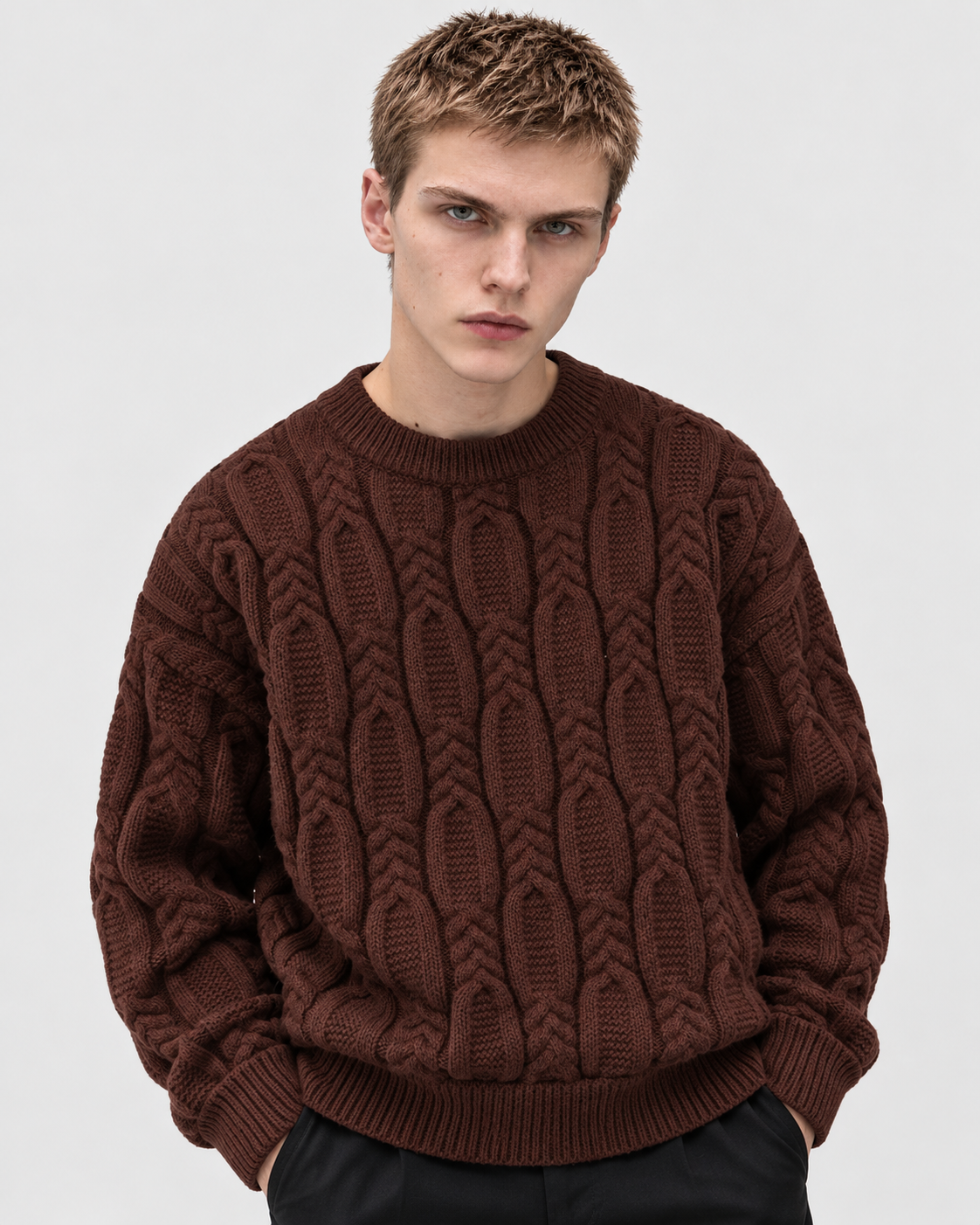 Image of Coffee | Male model wearing coffee-brown cable-knit sweater, relaxed front studio pose