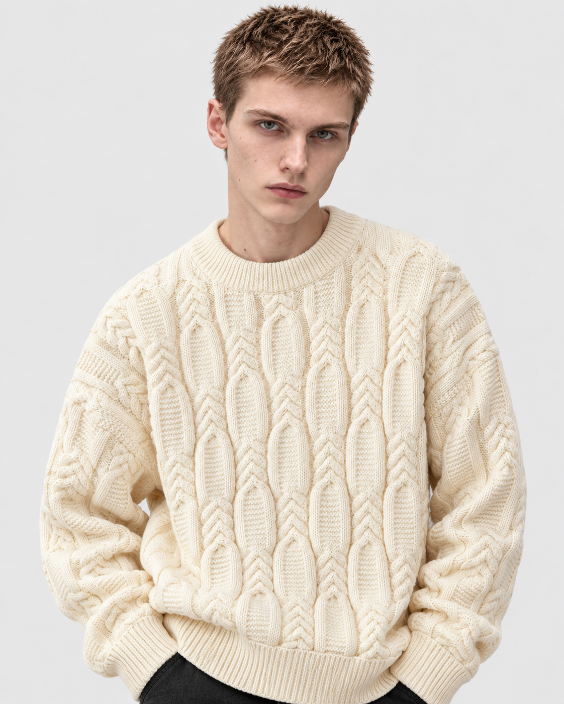 Image of Off-white | Male model wearing off-white cable-knit crewneck sweater, front studio pose