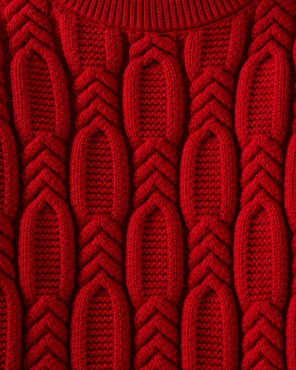Image of Red | Macro of bright red interwoven cable-knit fabric across the chest