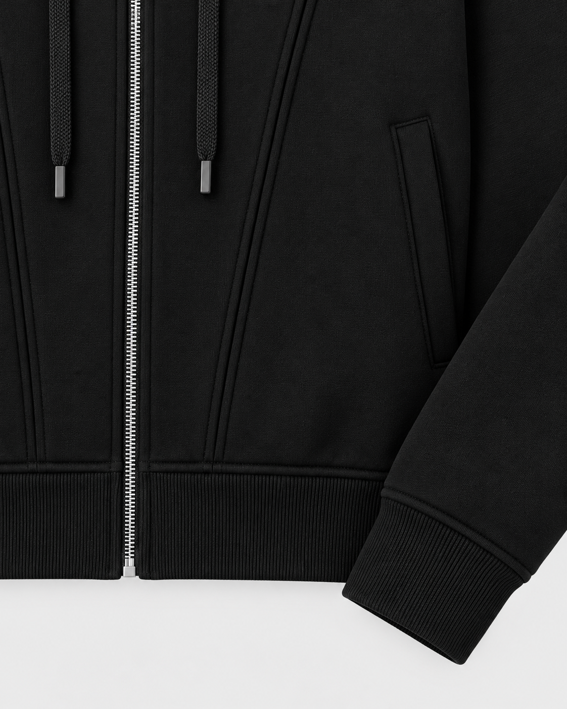 Black | Close-up of the zip-up hoodie's side pocket and ribbed sleeve cuff