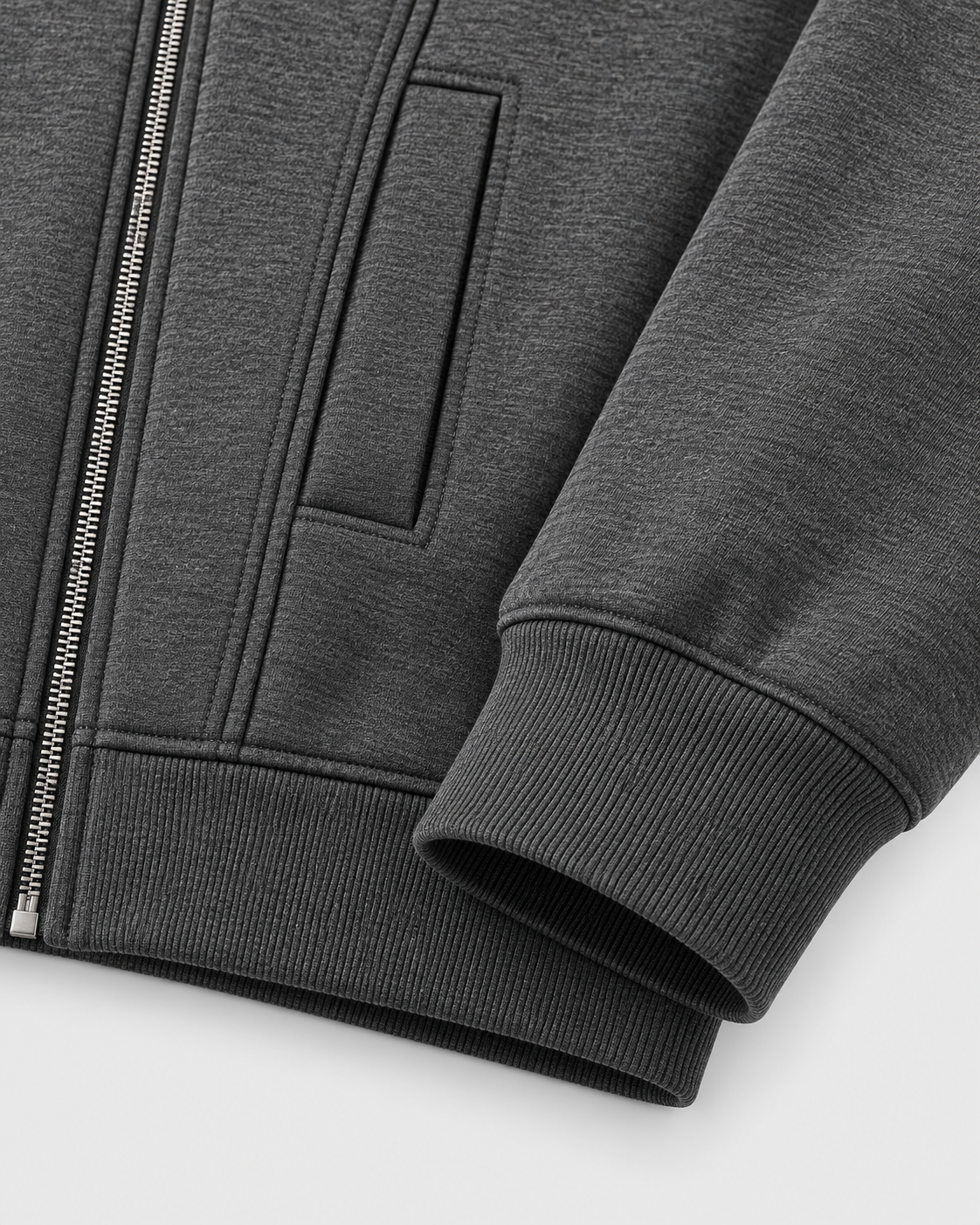 Gray | Close-up of the zip-up hoodie's side pocket and ribbed sleeve cuff