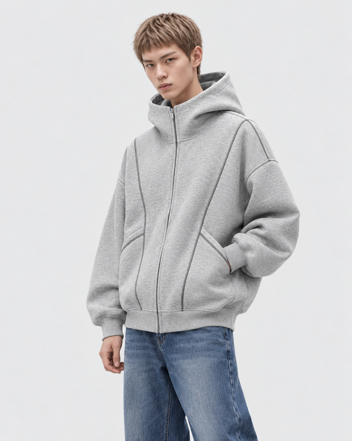 Image of Gray | Male model wearing a gray zip-up hooded sweatshirt in an alternate standing studio pose