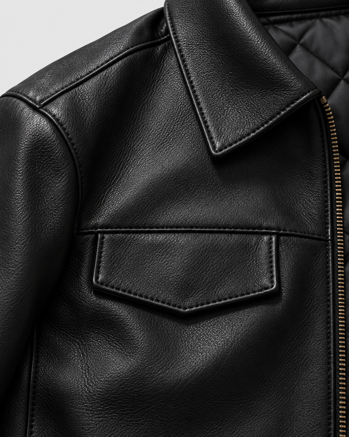 Black Padded | Chest pocket and zipper close-up on black faux leather jacket