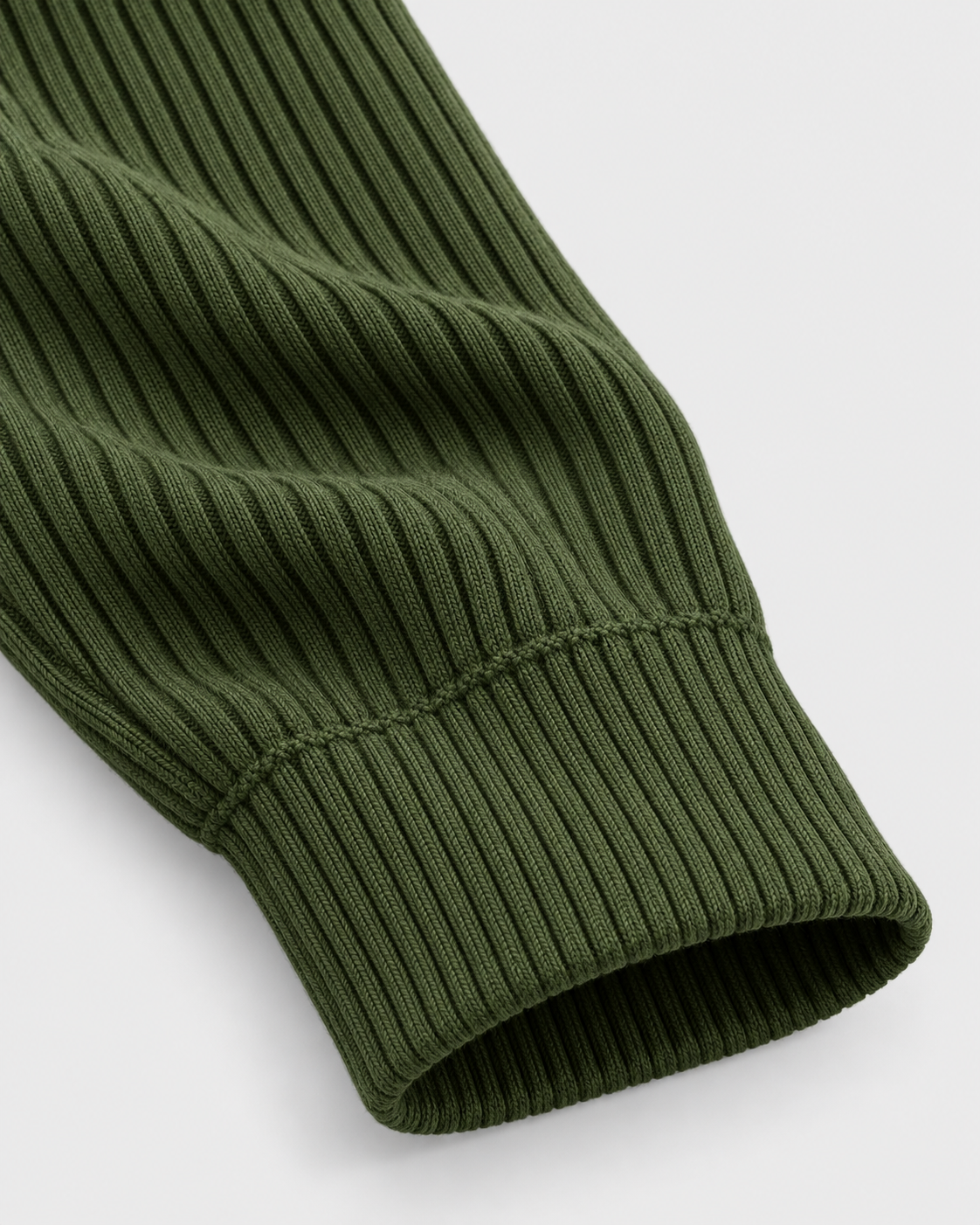 Army Green | Close-up of the green ribbed turtleneck sweater sleeve cuff and knit texture