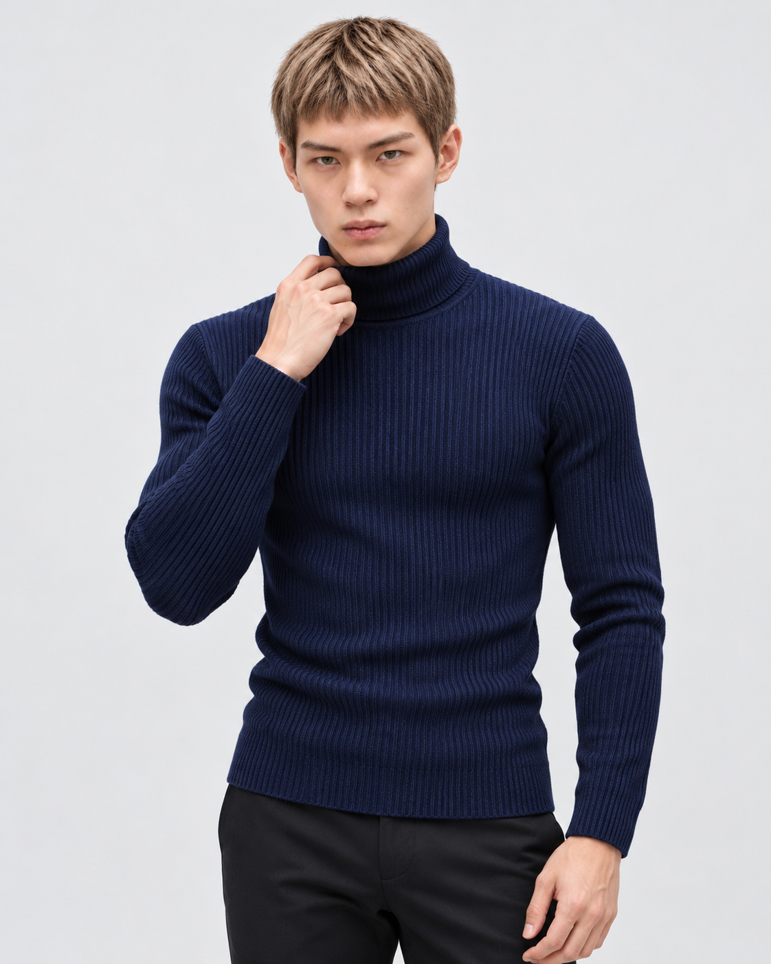 Image of Navy | Male model wearing the ribbed turtleneck sweater in a standing studio pose