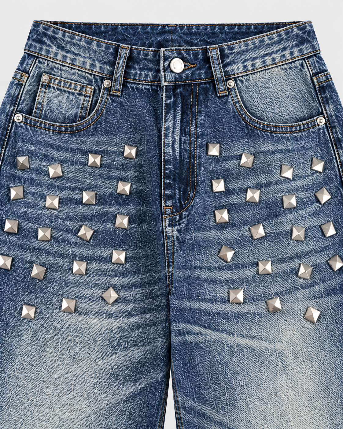 Image of Blue | Close-up of metallic studs on the upper legs of blue washed jeans