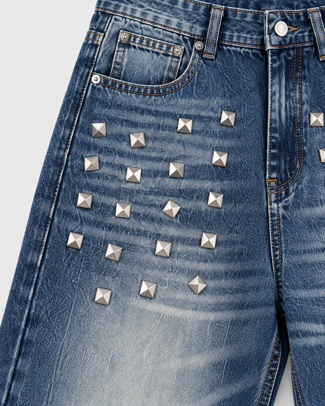 Image of Blue | Close-up of front pockets and metallic studs on blue washed jeans