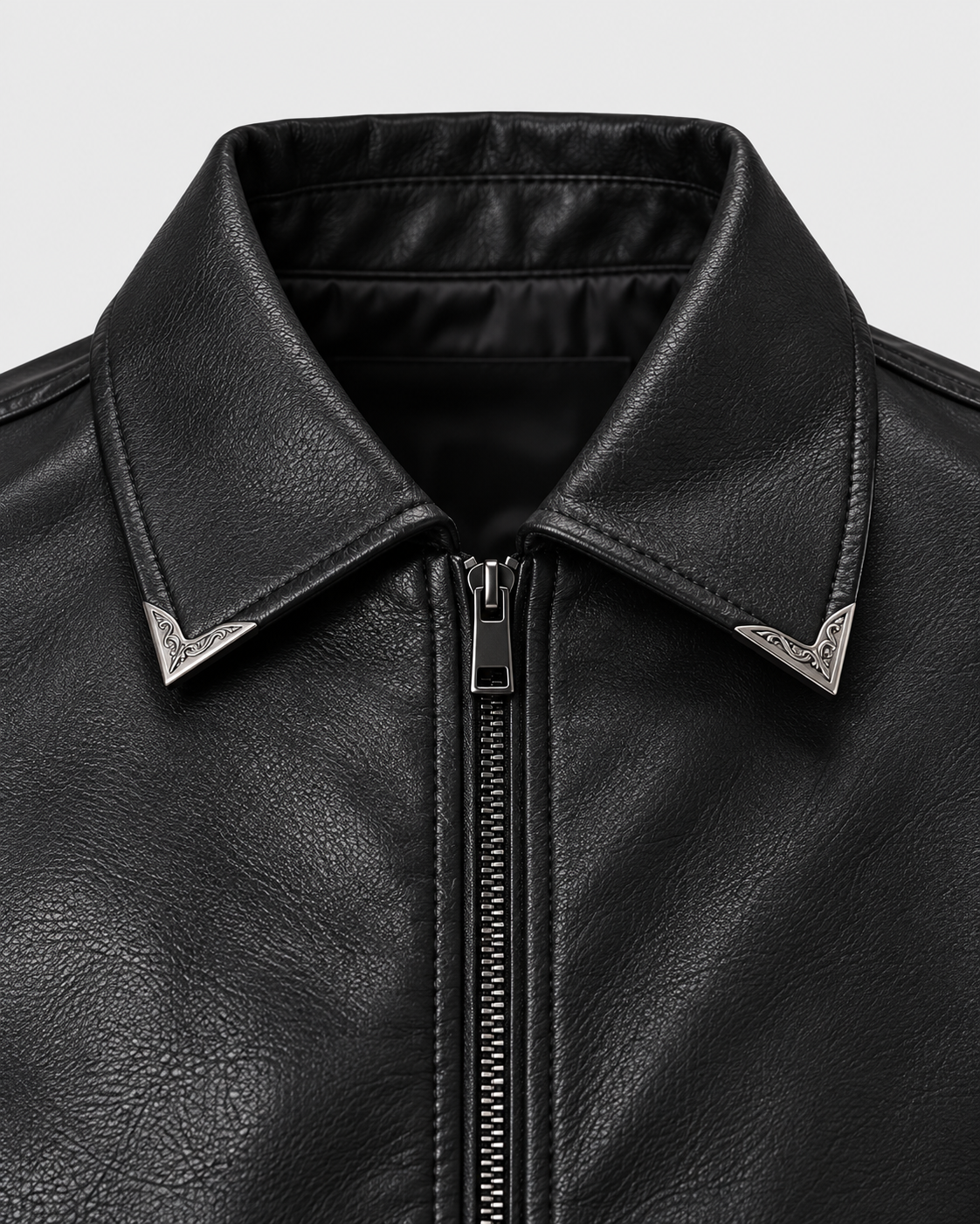 Image of Black | Close-up of the pointed collar and zipper on the black faux leather biker jacket