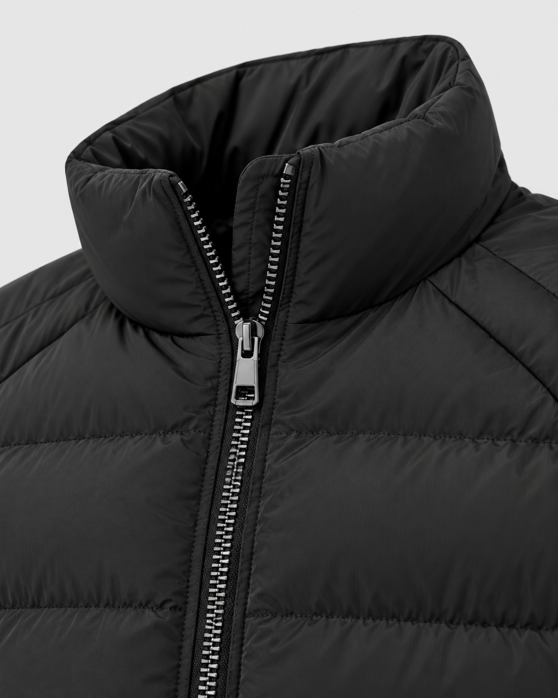 Black | Close-up of the high padded stand collar and center zipper on the puffer jacket