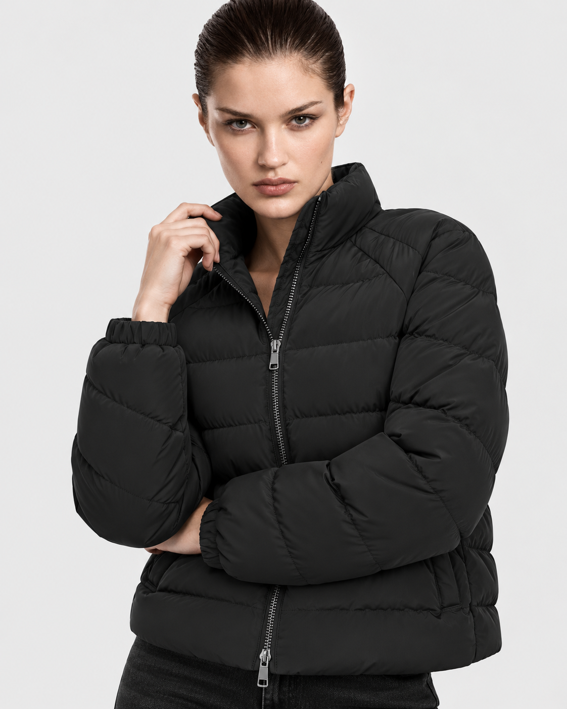 Image of Black | Female model wearing the oversized quilted stand-collar puffer jacket in an alternate studio pose