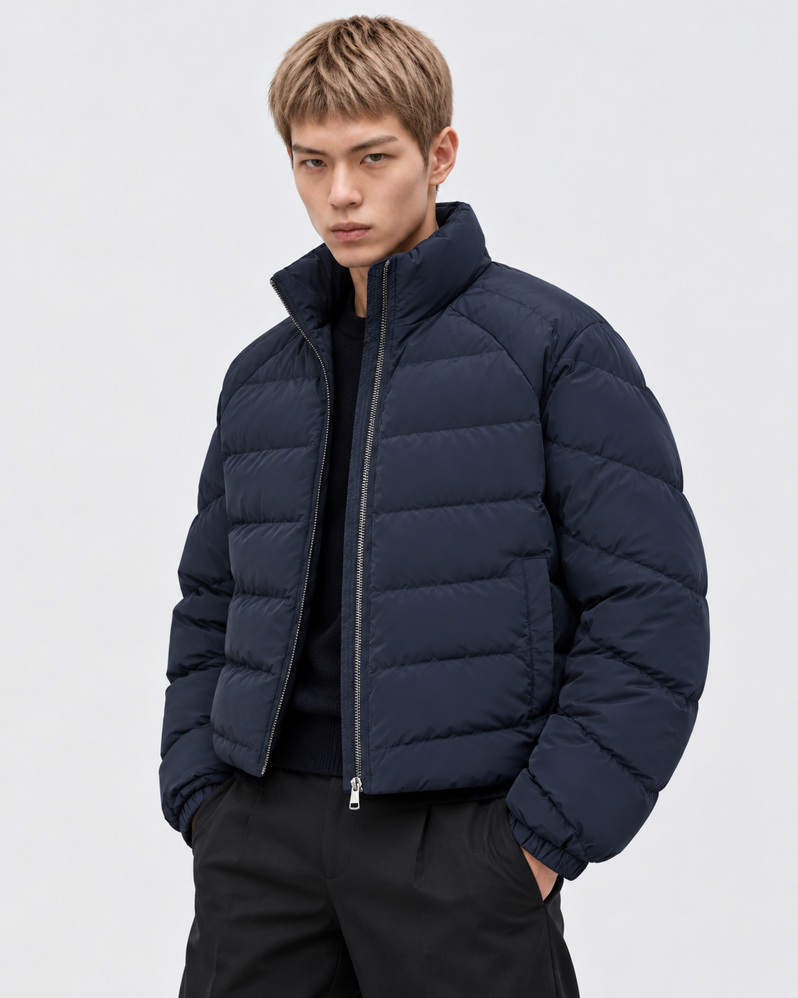 Image of Navy Blue | Male model wearing the navy blue oversized stand-collar puffer jacket with dark trousers