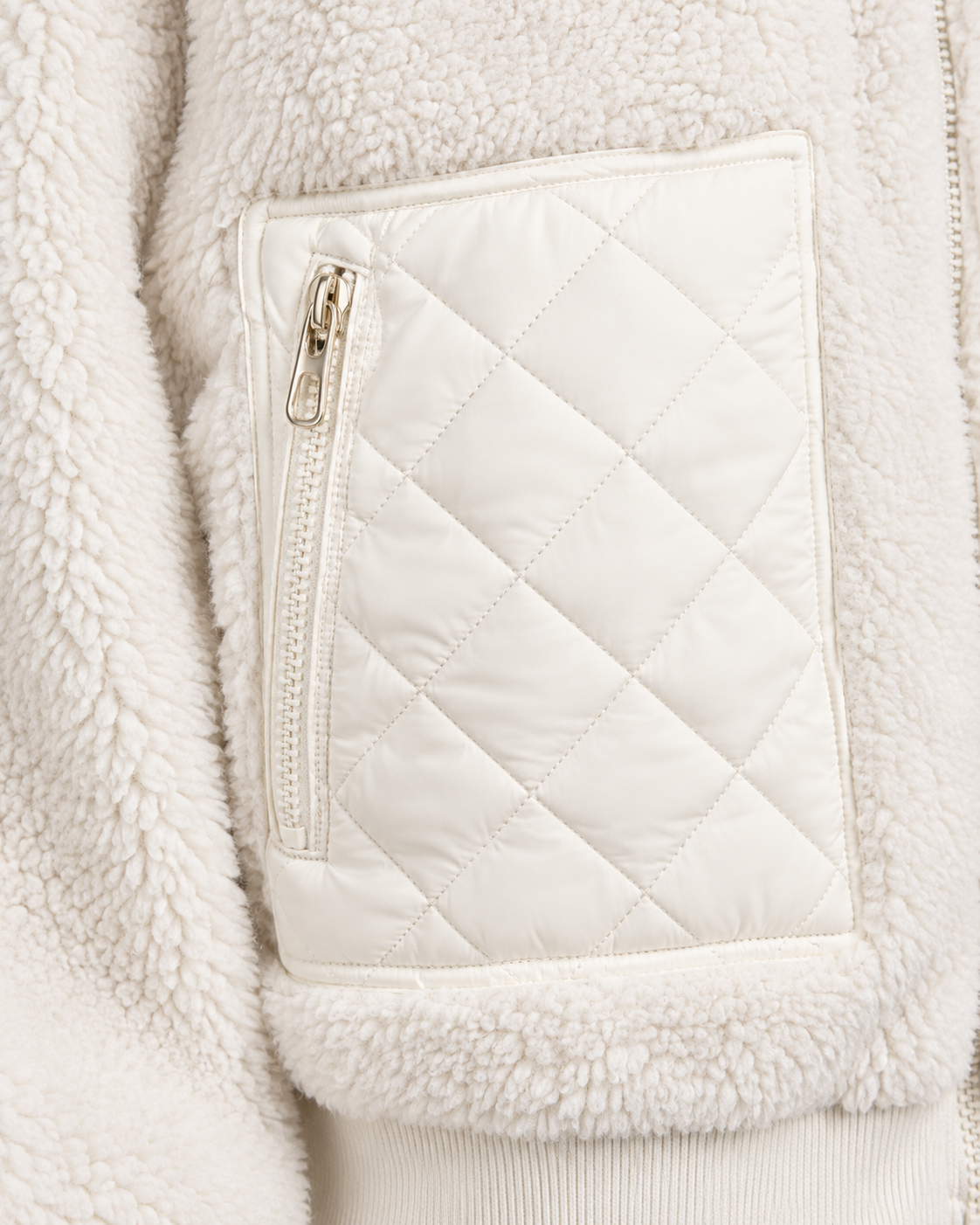 White | Close-up of zip pocket and quilted panel on white winter jacket