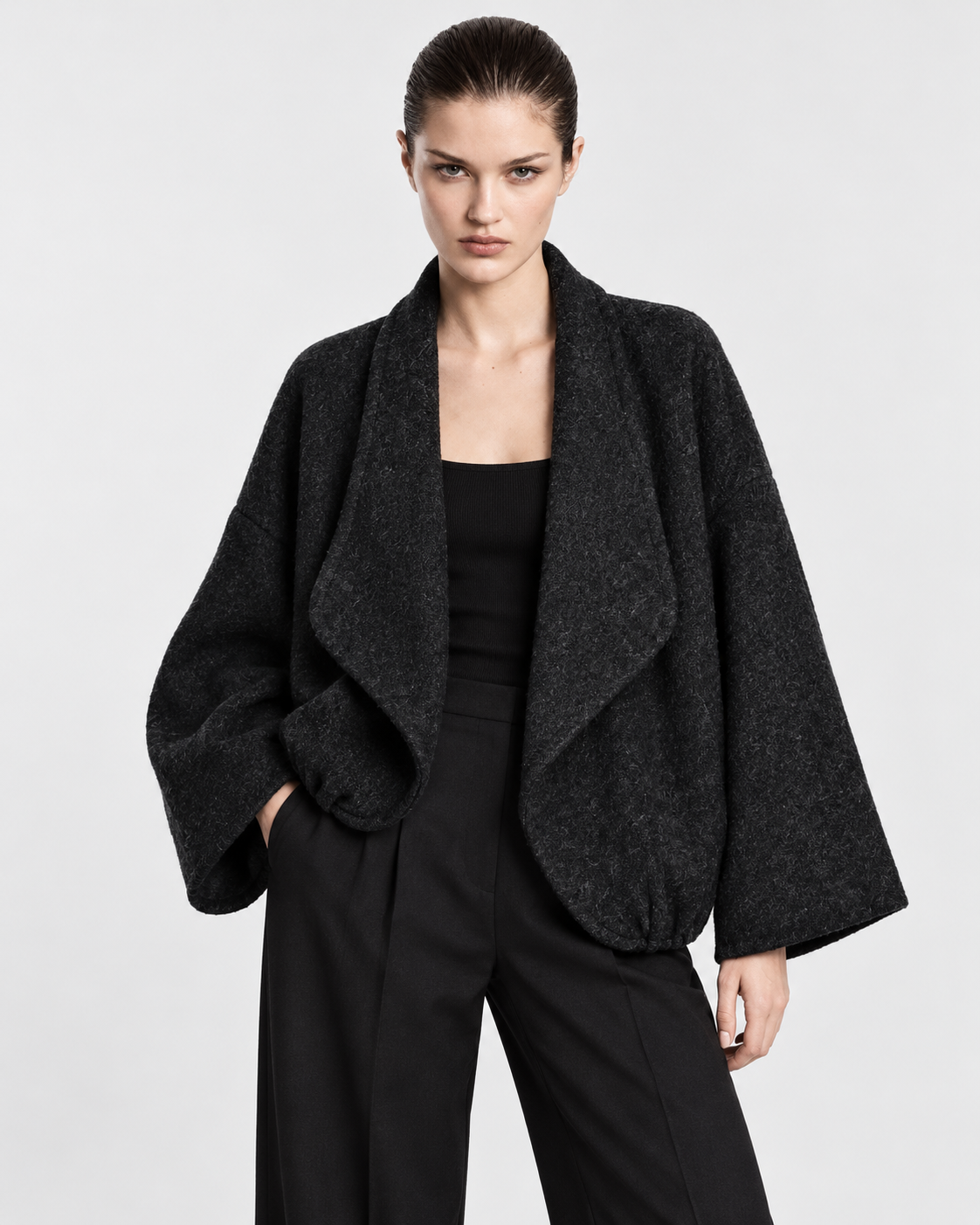 Image of Dark Gray | Model wearing women's charcoal-gray collared knit cardigan, front pose