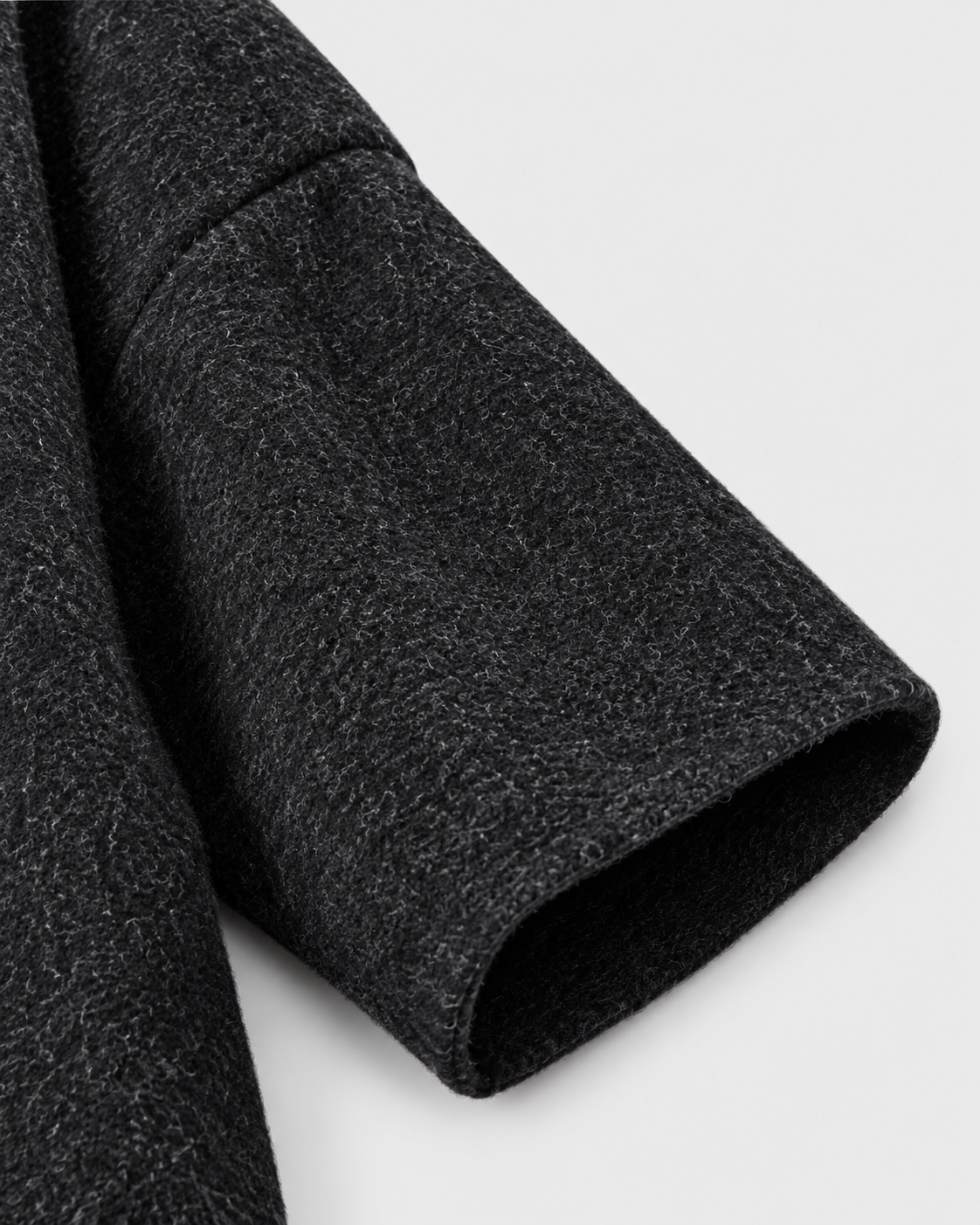 Dark Gray | Close-up of the sleeve and textured knit on charcoal cardigan