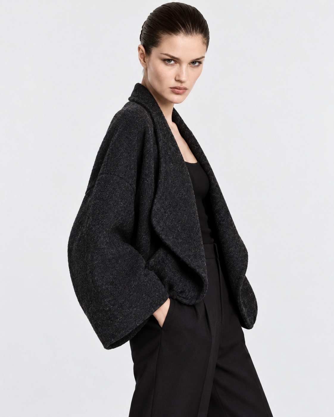 Image of Dark Gray | Model styling women's dark gray knit cardigan, alternate pose