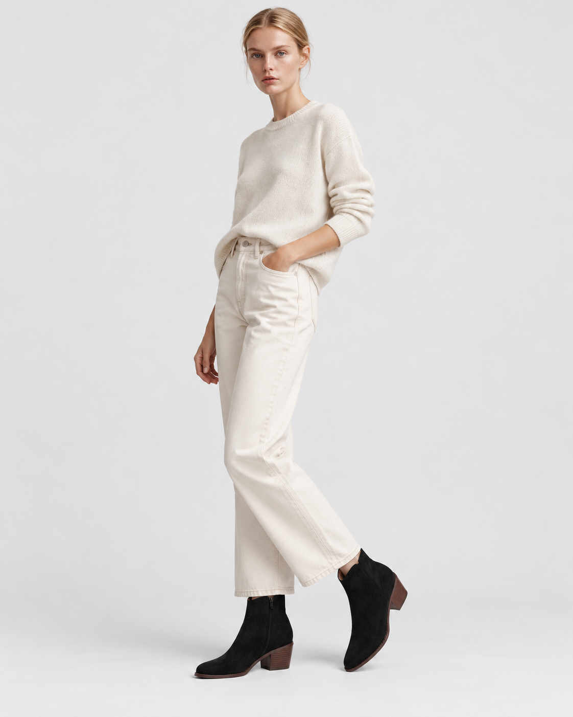 Black | Model wearing women's black pointed-toe ankle boots, standing studio pose