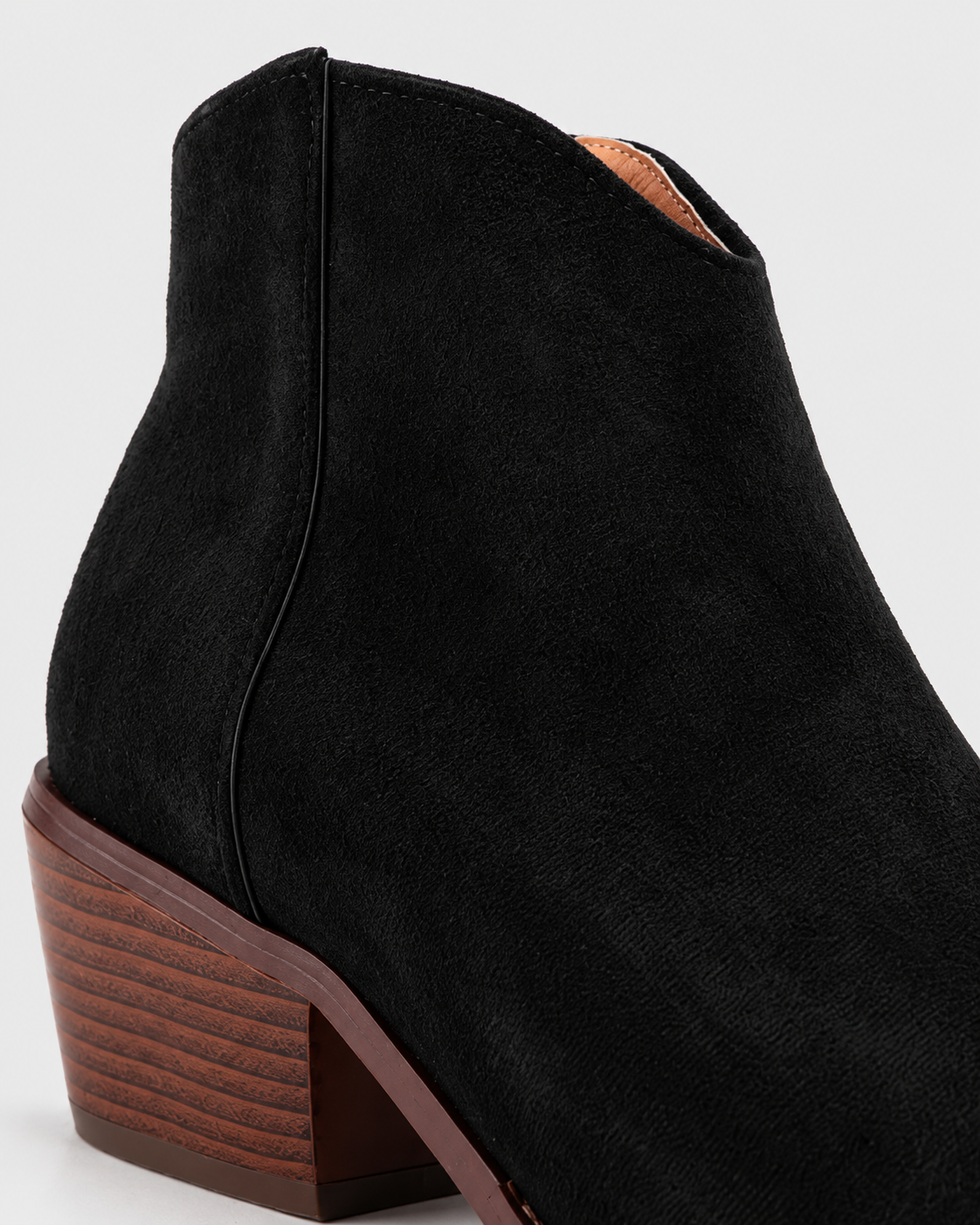 Image of Black | Close-up of black ankle boot side seam and stacked-look block heel