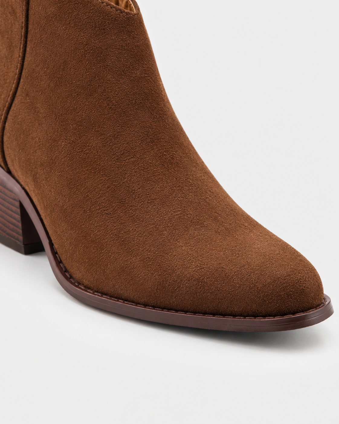 Image of Brown | Close-up of brown boot ankle shaft and pointed-toe construction
