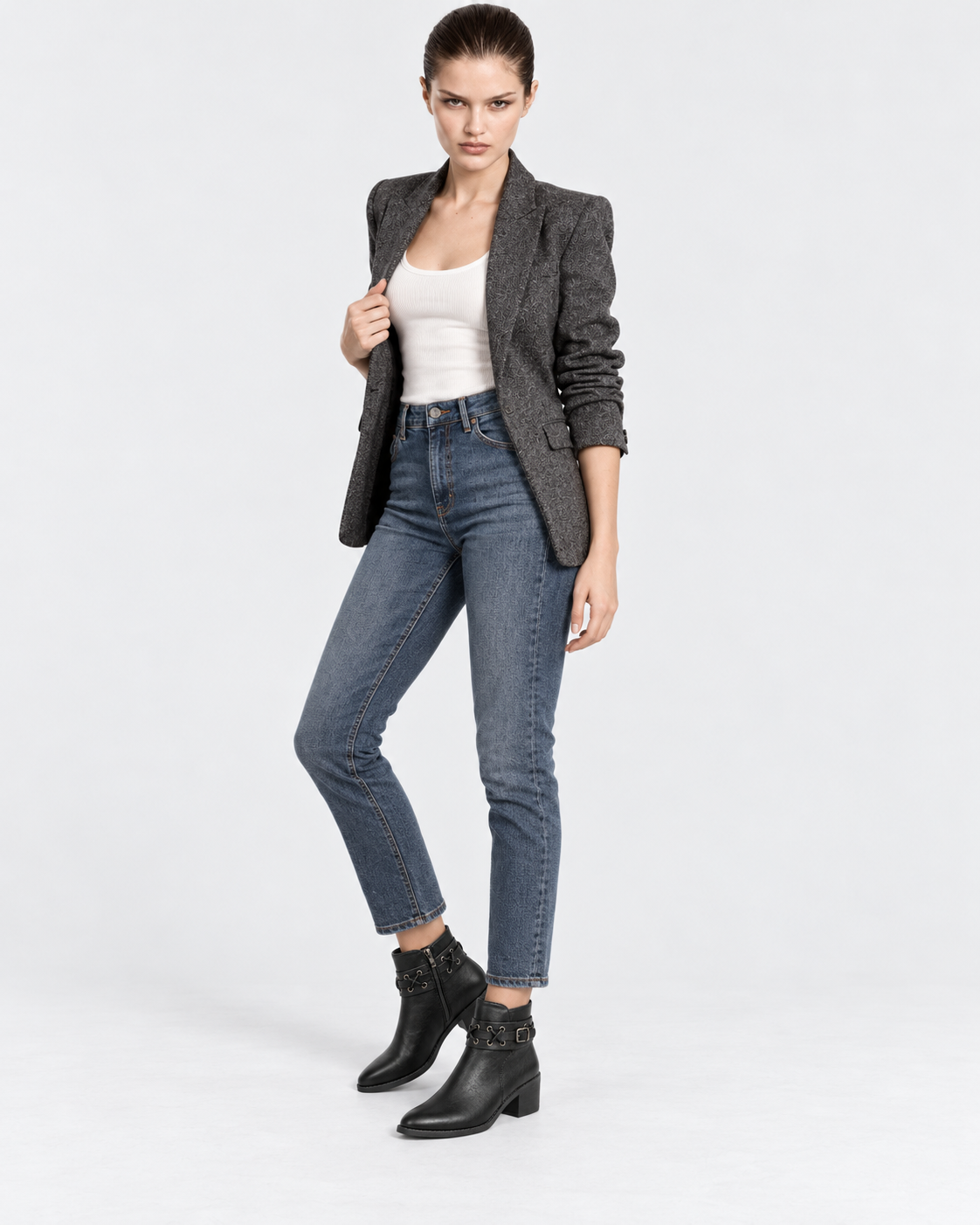 black | Model wearing black rivet buckle ankle boots, full-length studio pose