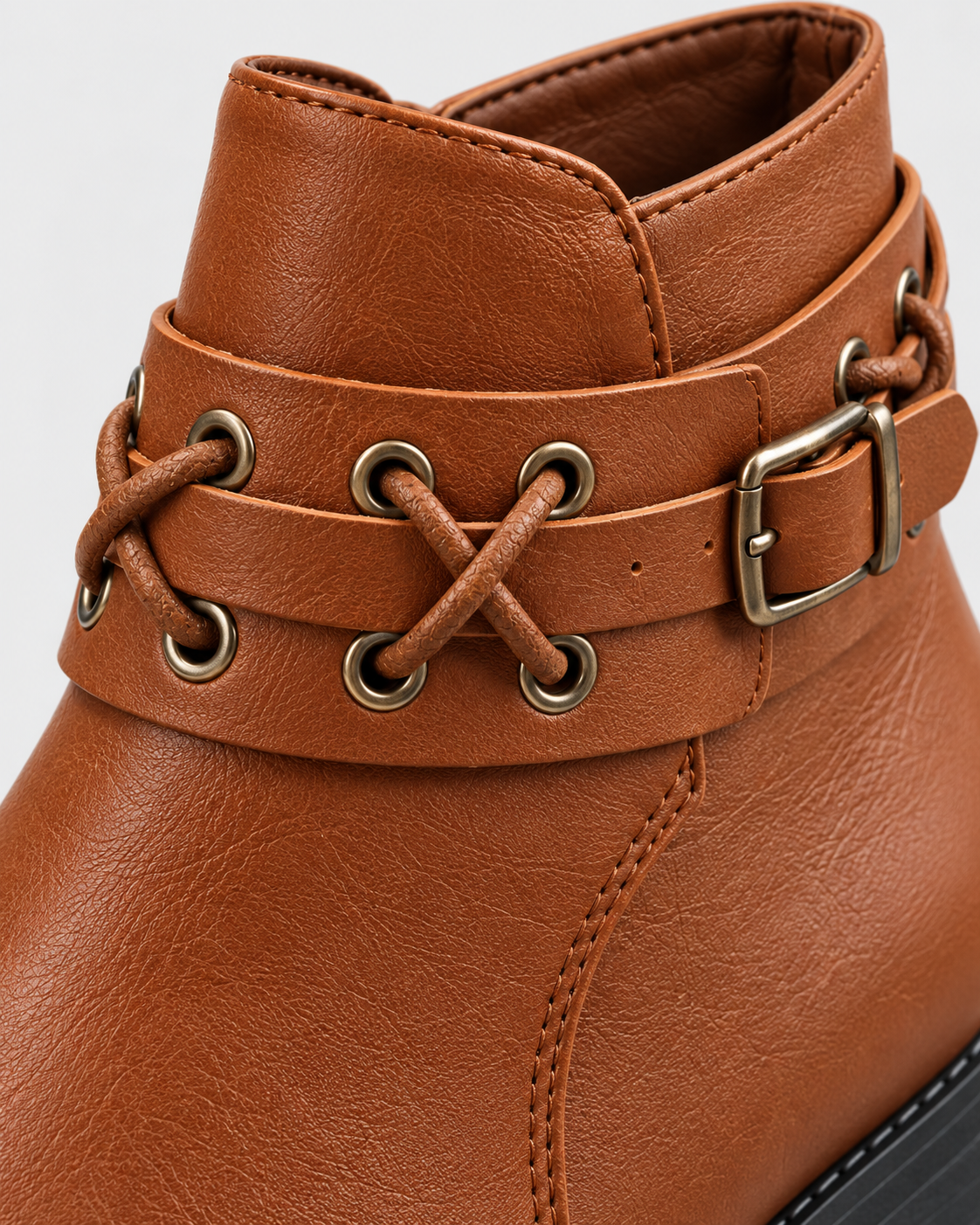 Light Brown | Close-up of decorative laced rivet strap on light brown ankle boot
