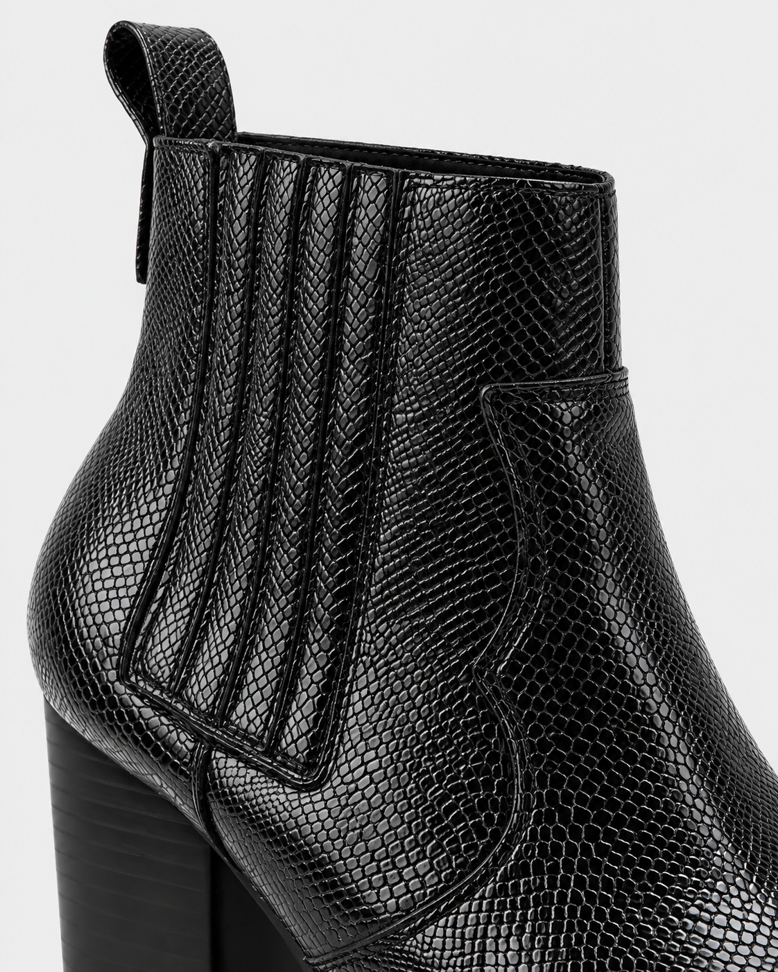Image of Black | Close-up of elastic side panel on snakeskin-print ankle boot
