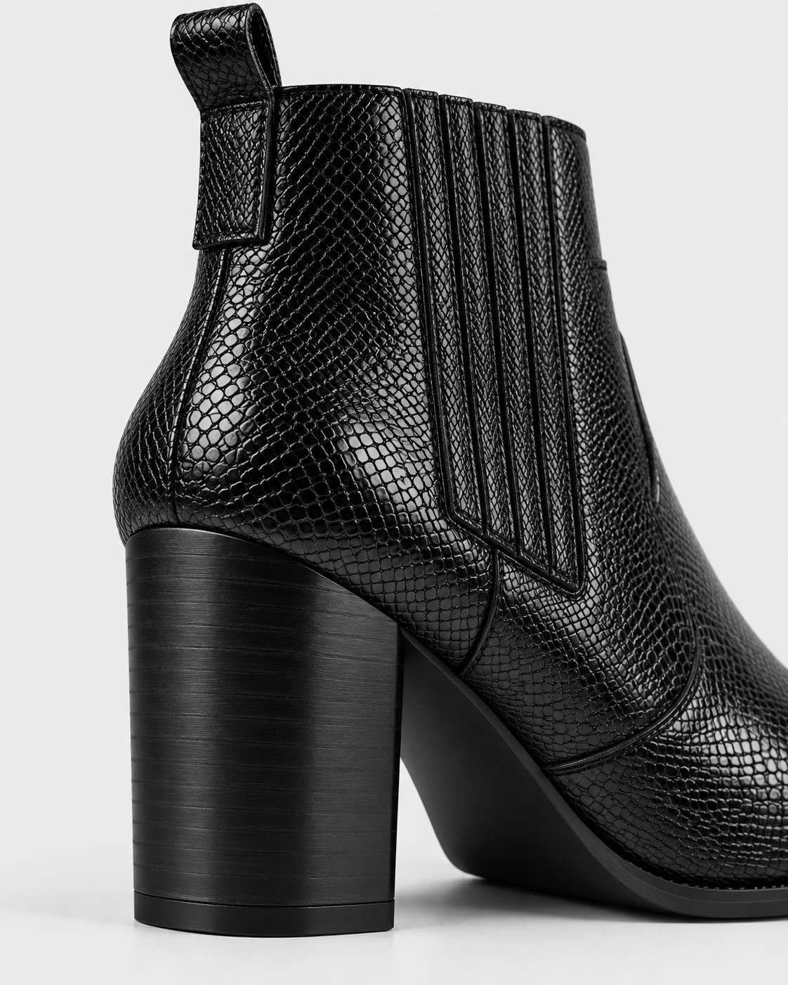 Image of Black | Close-up of black ankle boot block heel and snakeskin texture