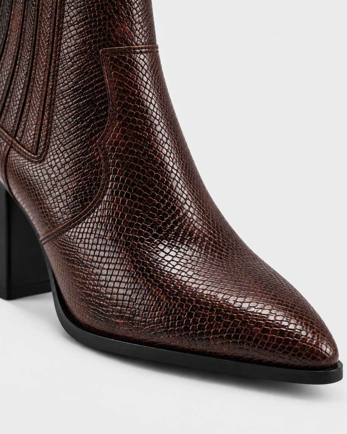 Brown | Close-up of brown snakeskin-print pointed toe on ankle boot
