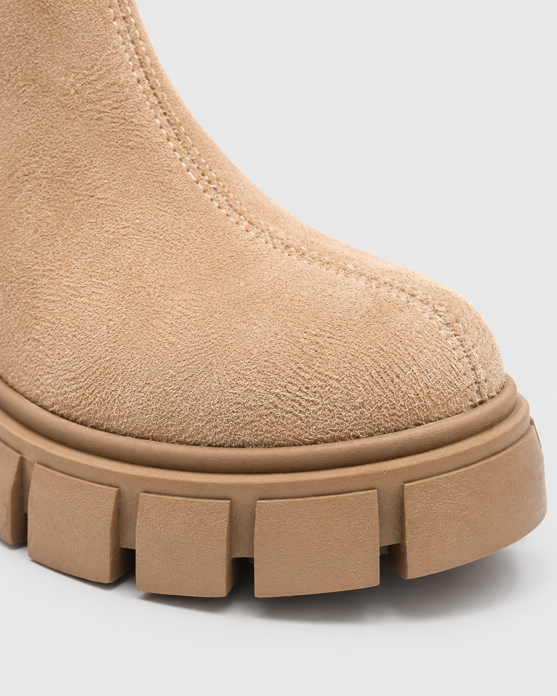 Apricot | Close-up of rounded toe and chunky lug sole on apricot ankle boot