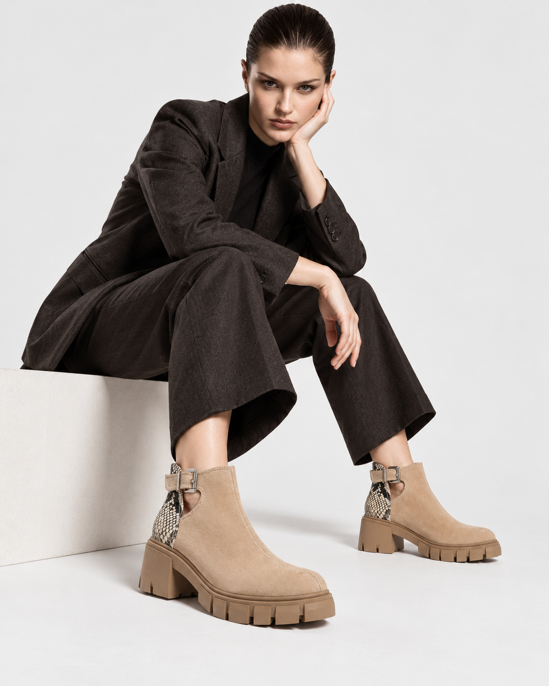 Image of Apricot | Seated model wearing apricot snakeskin-texture ankle boots