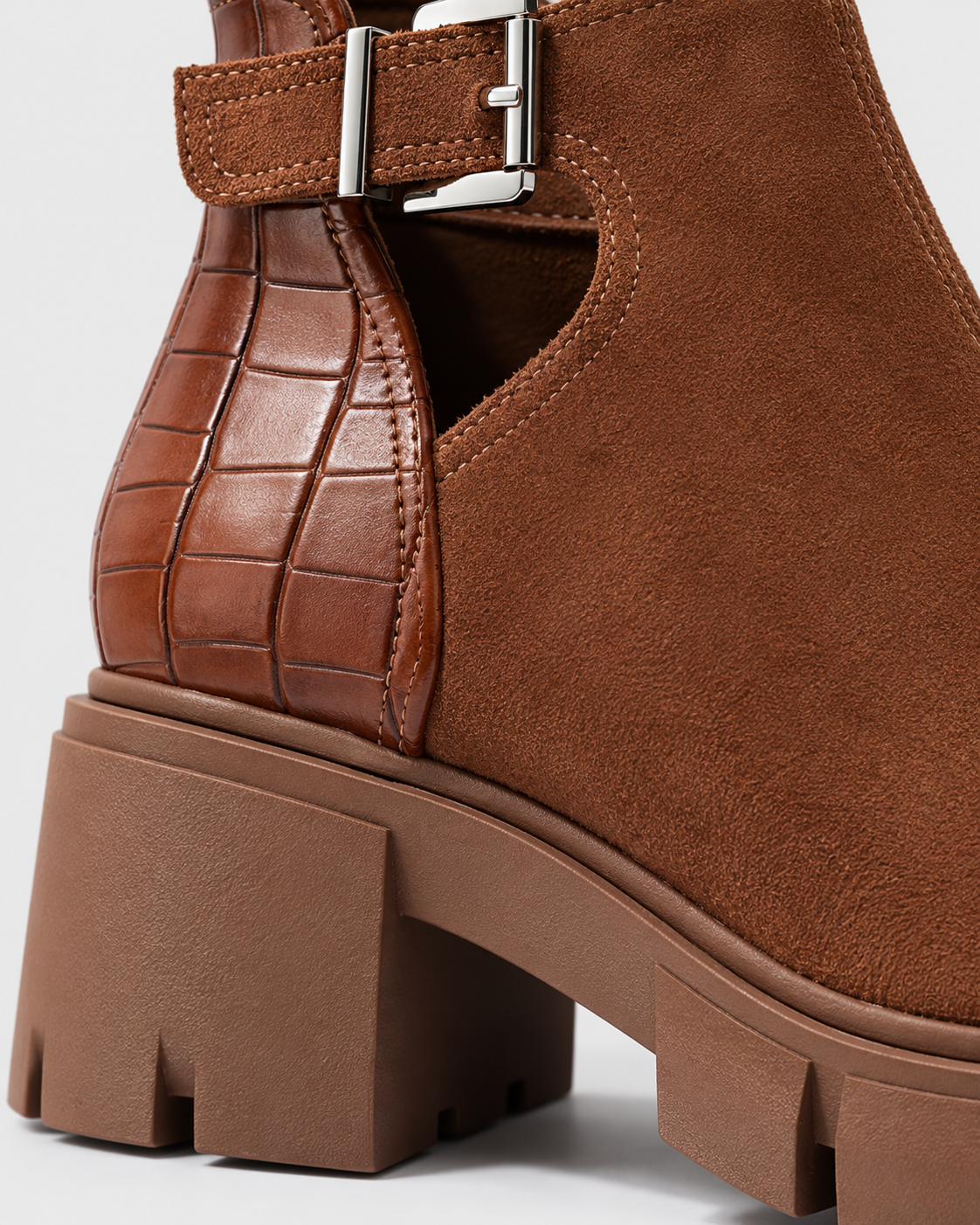 Brown | Close-up of ankle buckle and block heel on brown ankle boot